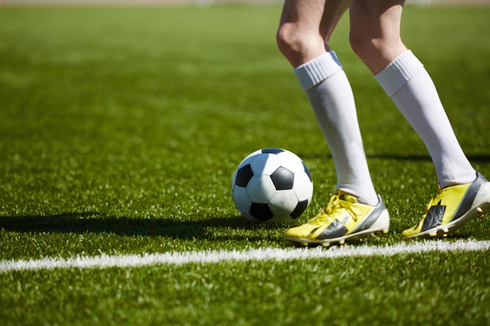 Fodboldspiller med gule fodboldstøvler